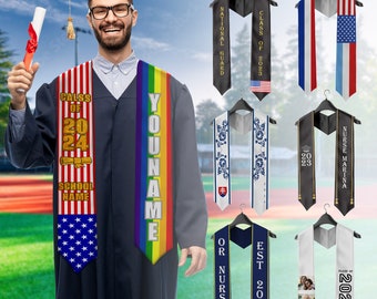 May include: A set of graduation sashes with various designs, including a rainbow sash with the text "YOUR NAME", a sash with the text "CLASS OF 2023", a sash with the text "NATIONAL GUARD", a sash with the text "NURSE MARINA", a sash with a photo of a group of people, and a sash with the text "EST. 2023 OR NURSE".
