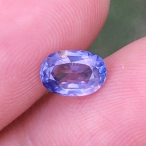 May include: A light blue oval-shaped gemstone with a faceted cut.