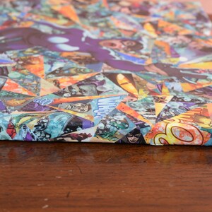 May include: A canvas print with a colorful collage of comic book pages. The collage is made up of various shapes and sizes of comic book pages, creating a geometric pattern. The colors in the collage are bright and vibrant, including red, yellow, blue, green, and purple.