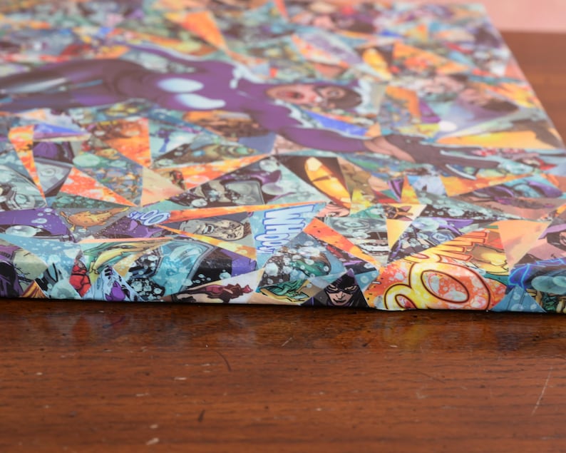 May include: A canvas print with a colorful collage of comic book pages. The collage is made up of various shapes and sizes of comic book pages, creating a geometric pattern. The colors in the collage are bright and vibrant, including red, yellow, blue, green, and purple.
