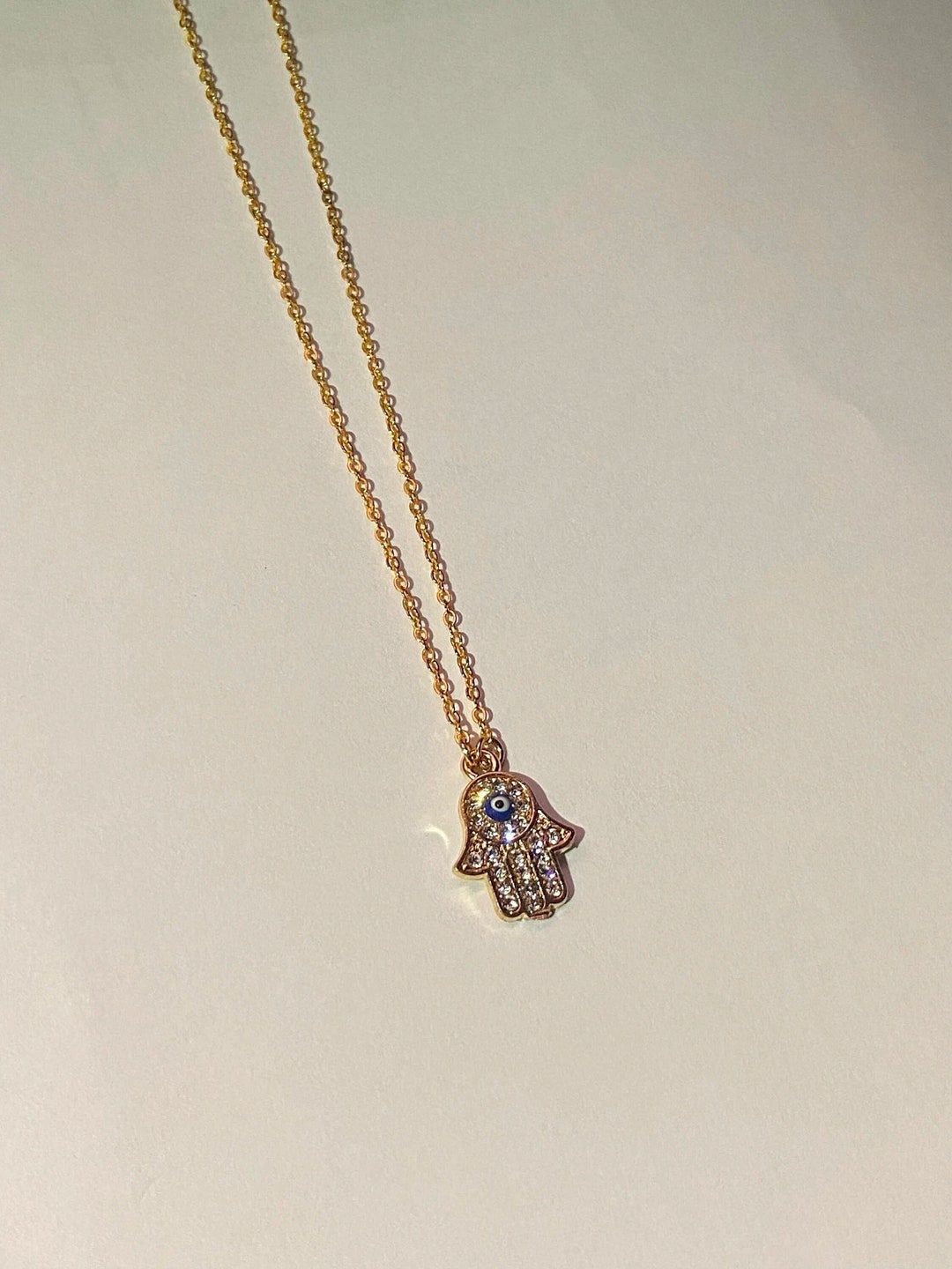 Brilliance Gold Tone Cubic Zirconia Teardrop, Evil Eye Coin, Hamsa & Round Simulated Turquoise Charms On Carabiner Paperclip Link Chain Necklace