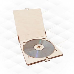 May include: A wooden CD case with a hinged lid, open to reveal a blank CD inside.
