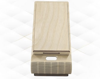 May include: A wooden phone stand with a decorative pattern. The stand is made of light wood and has a brown finish. The stand is designed to hold a phone upright.