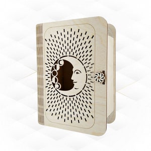 May include: A wooden box with a cutout design of a crescent moon and sun rays. The box has a small flower-shaped latch.
