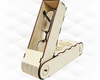 Puede incluir: Un estuche para gafas de madera con tapa con bisagras y mecanismo deslizante. El estuche está abierto y hay un par de gafas dentro. El estuche tiene un diseño decorativo en el exterior.