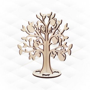 May include: A wooden tree cutout with a base and branches. The tree has leaves and fruit cutouts. The tree is a light brown colour.