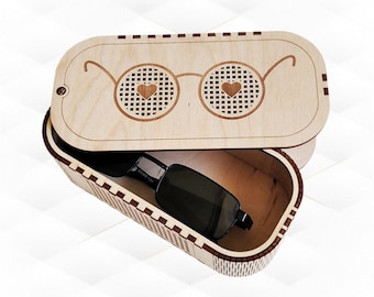 May include: A wooden box with a lid featuring a laser-cut design of glasses with hearts in the lenses. The box is open and a pair of sunglasses is inside.
