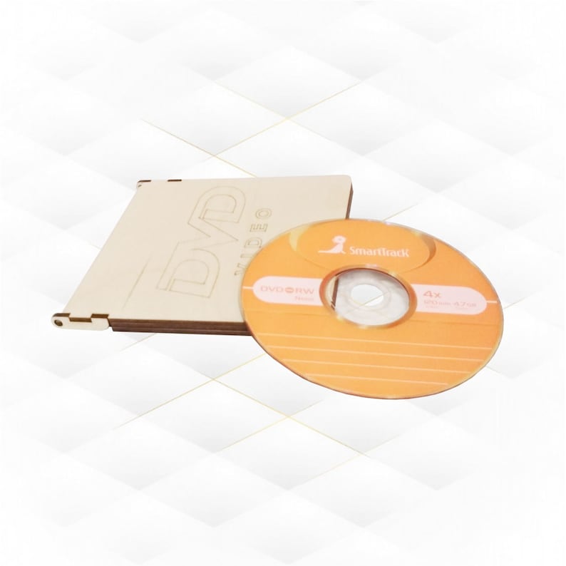 May include: A wooden DVD case with a DVD-RW disc inside. The disc is orange and has the text "Smartrack" and "4x DVD+RW 4.7GB" printed on it.