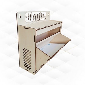 May include: A wooden wall-mounted organizer with a decorative cutout of birds on the top. It has two shelves and a small flap door on the bottom. The organizer is made of light wood and has a natural finish.