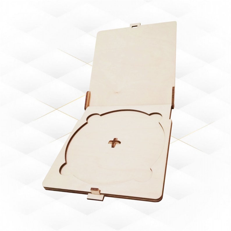 May include: A wooden CD case with a hinged lid and a cutout for a CD. The case is made of light-colored wood and has a simple design.