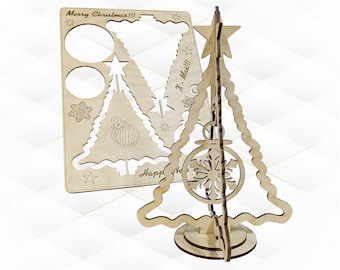 May include: A wooden Christmas tree ornament kit with a cutout design. The kit includes a base, a tree, a star, and a snowflake ornament. The tree is decorated with the text "Merry Christmas!!!" and "Happy New Year!"