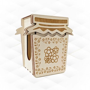 May include: A wooden tissue box shaped like a jar of jam. The box is light brown with a darker brown lid and floral design. The floral design is etched into the wood, adding a decorative touch to the tissue box.