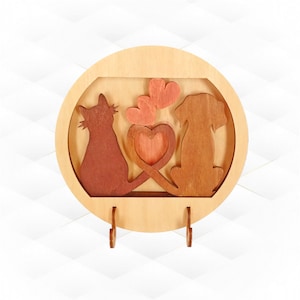 May include: A wooden wall-mounted key holder with a cat and dog silhouette design. The silhouettes are brown and the background is light wood. There are three hooks on the bottom for hanging keys. The design features hearts in the center.