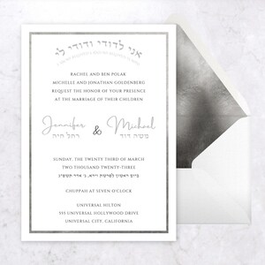 May include: A silver and white wedding invitation with the text "אני לדודי ודודי לי" in Hebrew. The invitation announces the marriage of Jennifer and Michael on Sunday, March 23, 2023, at 7:00 PM at the Universal Hilton in Universal City, California.