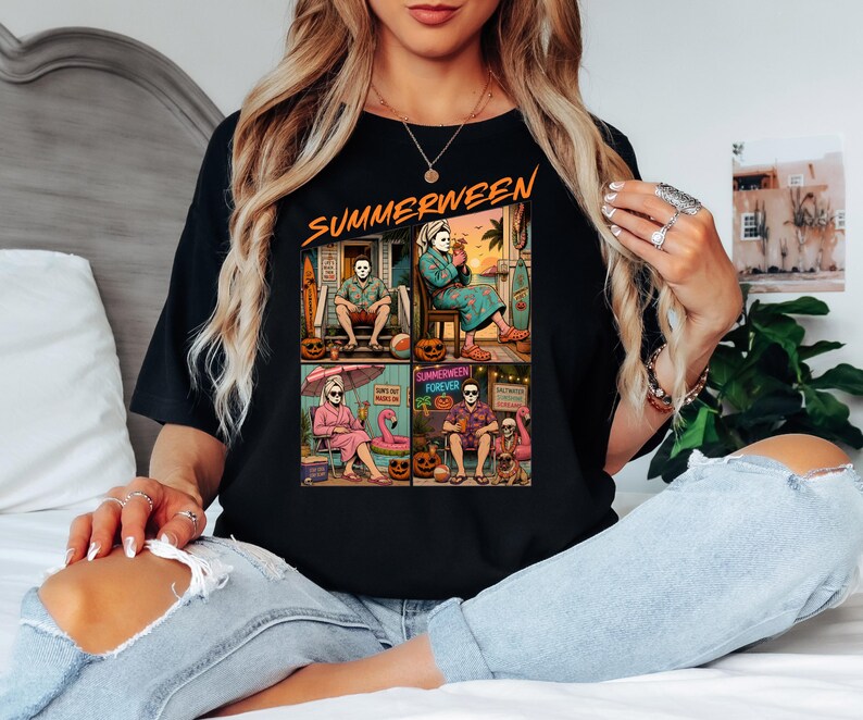 May include: A black t-shirt featuring a graphic print with the text "SUMMERWEEN" at the top. The design is divided into four panels showing characters in summer settings with pumpkins, beach gear, and tropical drinks, blending horror and vacation themes.