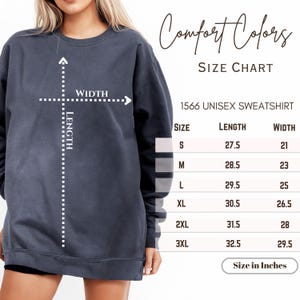 a woman wearing a sweatshirt with a cross on it