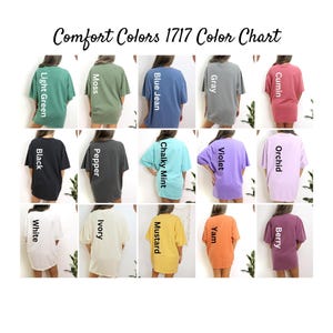 May include: A Comfort Colors 1717 color chart featuring fifteen short-sleeve t-shirts in various colors including Light Green, Moss, Blue Jean, Gray, Cumin, Black, Pepper, Chalky Mint, Violet, Orchid, White, Ivory, Mustard, Yam, and Berry.