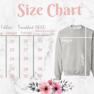 May include: A size chart for a Gildan 18000 sweatshirt, with measurements for sizes S to 2XL. The chart includes weight, length, and sleeve length measurements. A gray sweatshirt is shown on a marble background.