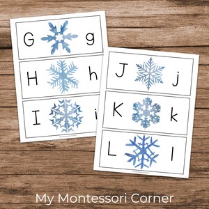 May include: A set of printable flashcards featuring the letters G, H, I, J, K, and L with a blue watercolour snowflake design. Each card has the letter in uppercase and lowercase.