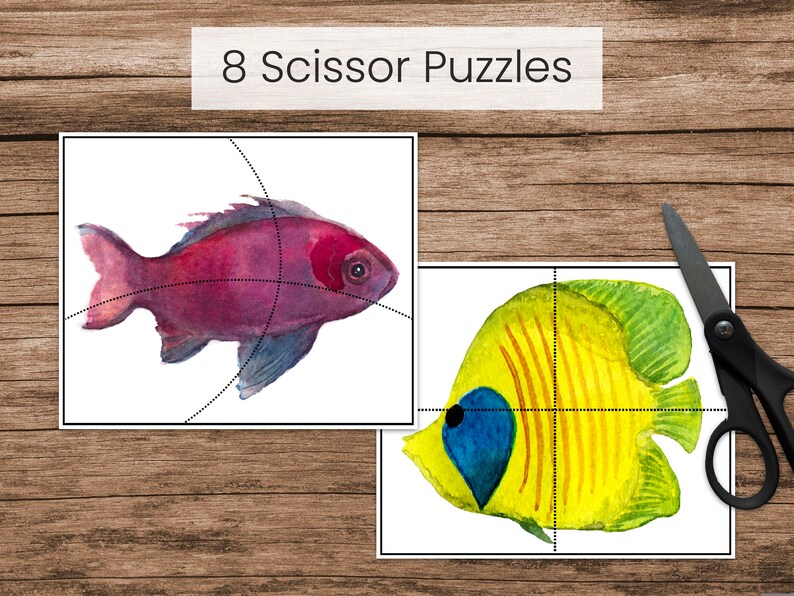 May include: Two printable scissor puzzles featuring watercolor illustrations of fish. The first puzzle shows a pink fish with black lines dividing it into eight sections. The second puzzle shows a yellow fish with black lines dividing it into eight sections.