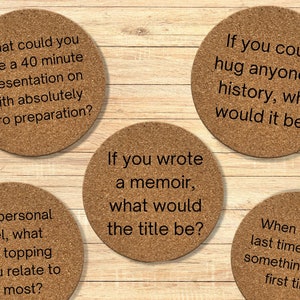 May include: Five cork coasters with thought-provoking questions printed on them. The questions are: "What could you give a 40 minute presentation on with absolutely zero preparation?", "On a personal level, what pizza topping do you relate to the most?", "If you wrote a memoir, what would the title be?", "If you could hug anyone in history, who would it be?", and "When was the last time you did something for the first time?"