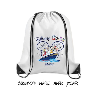 May include: A white drawstring backpack featuring a graphic of a cruise ship with Disney characters, including Mickey and Minnie Mouse, inside a large blue Mickey Mouse ear outline. The text reads Disney Cruise, 202?, and Name, with custom name and year.