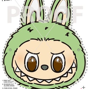 May include: A printable Halloween mask featuring a cartoon character with a green hood, large brown eyes, and a toothy grin. The mask has instructions for cutting and assembly, with the text "LABUBU INSPIRED HALLOWEEN MASK" at the top. Copyright 2025 99CentMasks.com.
