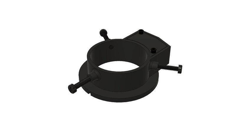 May include: Black metal telescope mount with adjustable screws. The mount has a circular base and a ring with a square attachment point.