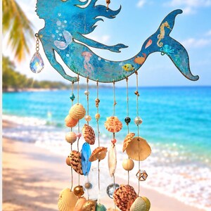 May include: A blue mermaid-shaped wall hanging featuring a distressed finish and illustrations of sea creatures. Multiple strings hang from the mermaid, decorated with various seashells, clear glass beads, wooden spheres, and a faceted crystal drop.