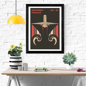 May include: A vintage-style poster featuring a McDonnell Douglas MD-80 airplane in flight. The airplane is depicted in a dark brown color with red and white stripes on the tail. The poster has a black frame.