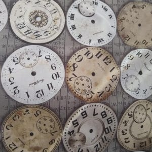 May include: A fabric design featuring a repeating pattern of vintage-style clock faces in various shades of gray and white. The clocks have Roman numeral and Arabic numeral markings.