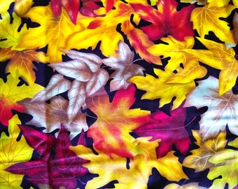 May include: A fabric with a pattern of colorful autumn leaves. The leaves are in shades of yellow, orange, red, and brown. The fabric is perfect for crafting projects, such as quilts, pillows, and bags.