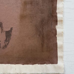May include: Abstract artwork on canvas featuring shades of brown and tan. The painting has a raw, unfinished edge with visible canvas texture. The color palette includes deep browns and lighter tan hues, creating a textured, earthy aesthetic.