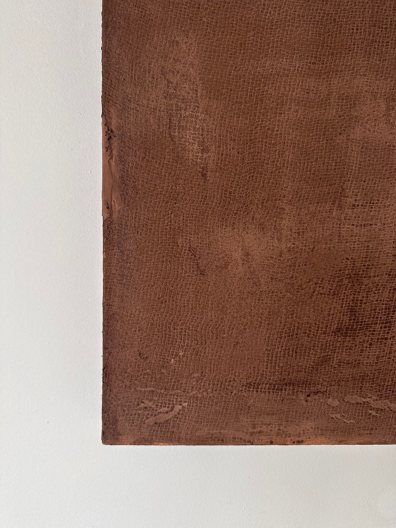 May include: A close-up of a brown textured surface with a fine, woven pattern. The surface is smooth and appears to be made of a durable material.