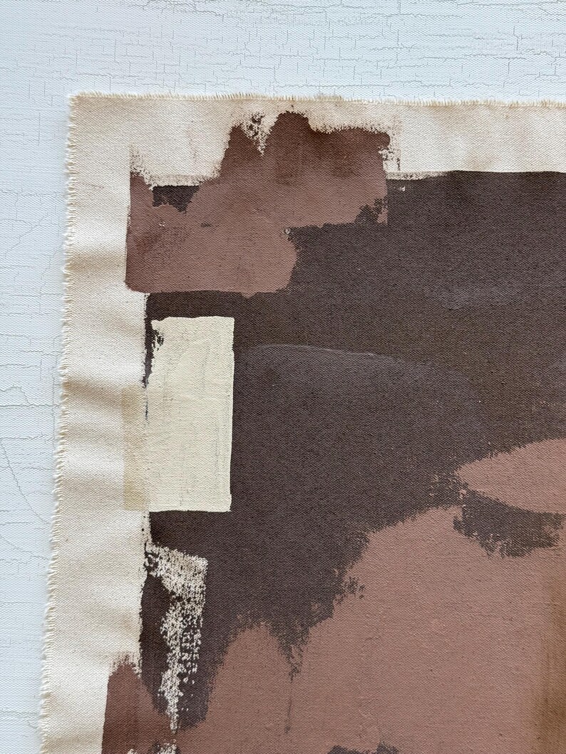 May include: Abstract art canvas with a raw edge. The artwork features a palette of brown, beige, and off-white brushstrokes. The composition includes rectangular and irregular shapes, creating a modern and textured aesthetic.