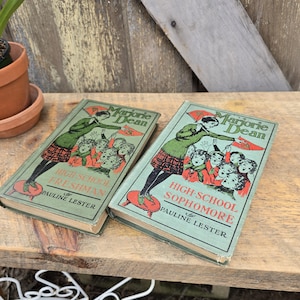 May include: A white ceramic mug with a black handle and the text "But First, Coffee" in a handwritten style. The mug is likely 4 inches tall and holds approximately 12 ounces of liquid.