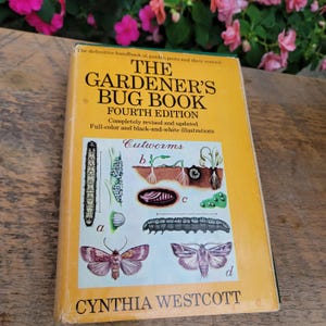 May include: A vintage copy of "The Gardener's Bug Book, Fourth Edition" by Cynthia Westcott. The book has a yellow cover with illustrations of insects and the title in large, bold letters. The book is a handbook for garden pests and their control.