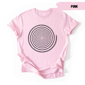 A pink t-shirt with a spiral design on it.