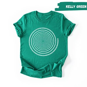 A green t-shirt with a spiral design on it, displayed against a white background.