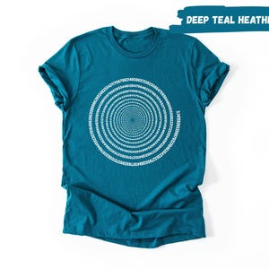 A teal-colored t-shirt with a spiral design printed on it, displayed against a white background.