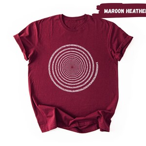 A maroon t-shirt with a white spiral design on the front.