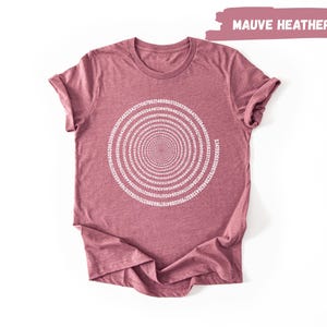 a maroon t-shirt with a white spiral design on it, laid out on a white background.