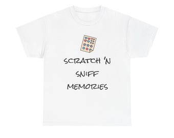 May include: White t-shirt with the text "SCRATCH 'N SNIFF MEMORIES" in black font. Above the text is a small illustration of a scratch-and-sniff card with heart, star, and circle shapes in pink, blue, and yellow.