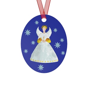 May include: A blue oval Christmas ornament with a white angel holding a candle. The angel has a yellow halo and gold accents on the dress. The background is blue with white snowflakes.