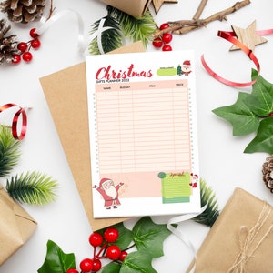 Peut inclure: Un planificateur de cadeaux de No&euml;l imprimable avec une illustration festive de P&egrave;re No&euml;l rouge et blanc. Le planificateur comporte des colonnes pour le nom, le budget, l'article et le prix.