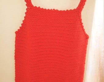 May include: A red crochet tank top with a scalloped neckline and straps. The top is made of a fine yarn and has a delicate, feminine look.