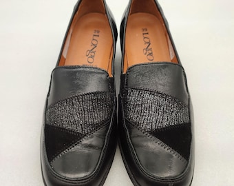 May include: Black leather loafers with a geometric pattern and the text "LONGO" on the inside of each shoe.