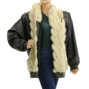 May include: A black leather jacket with a white fur collar and lining. The jacket has a zipper closure and a stand-up collar.