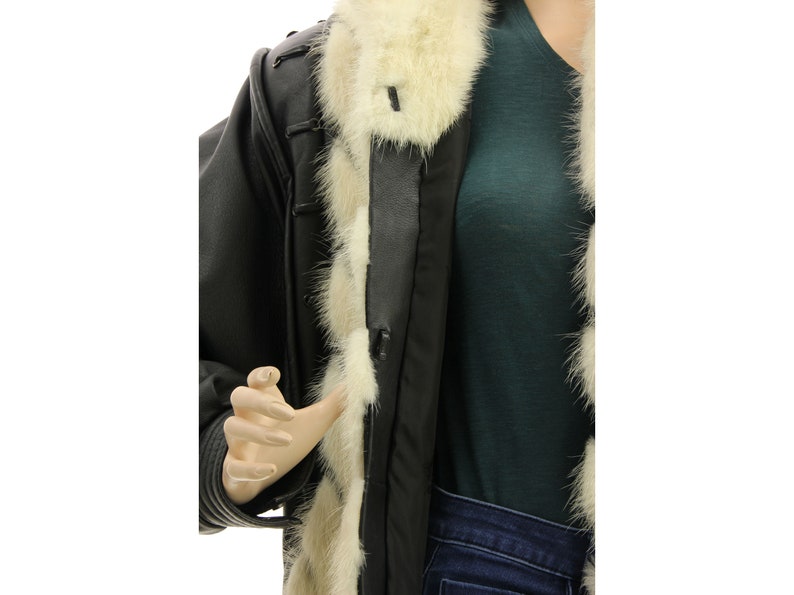 May include: A black leather jacket with a white fur collar and lining. The jacket has a zipper closure and a belt.