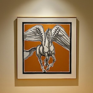 May include: Framed artwork featuring a stylized illustration of a winged horse, Pegasus, in shades of gray and black against an orange background. The artwork is enclosed in a white frame with a black border.
